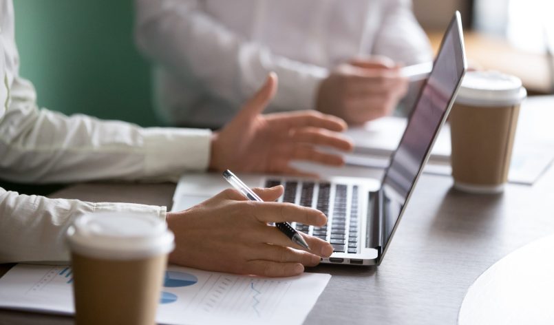 Businesswoman using laptop presenting project report at business Businesswoman using laptop presenting project statistics report or market analysis at meeting, making offer or financial forecast, consulting clients, discussing work or negotiating, close up view